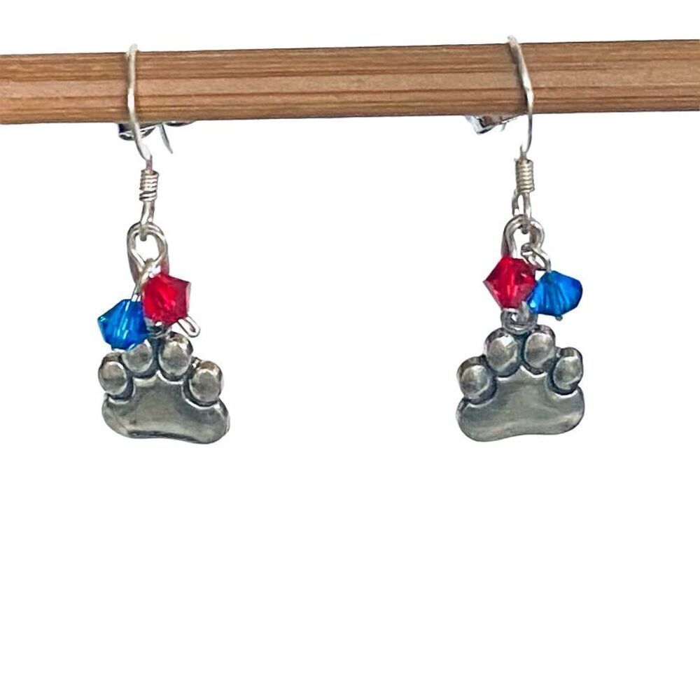 KU Just Cute Dangle Silver Paws Earrings With Red/blue accent crystals.